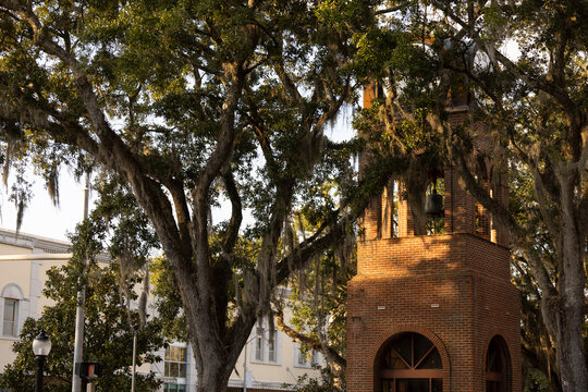 Late afternoon view of a historic brick clock tower in downtown Gainesville, Florida, USA.