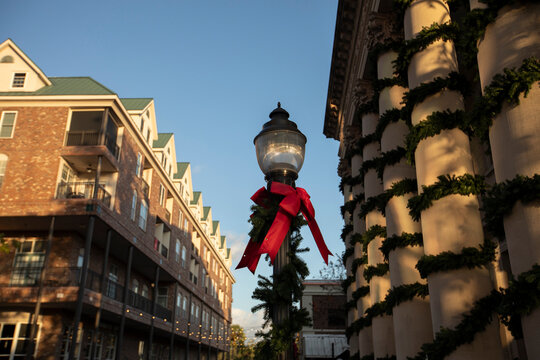 Christmas decorations cover a historic wrought iron street light in downtown Gainesville, Florida, USA.