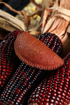 Cornmeal mush pastry served on ears of corn of various colors.