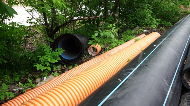 Corrugated plastic pipes prepared for underground utility installation and modern infrastructure construction projects