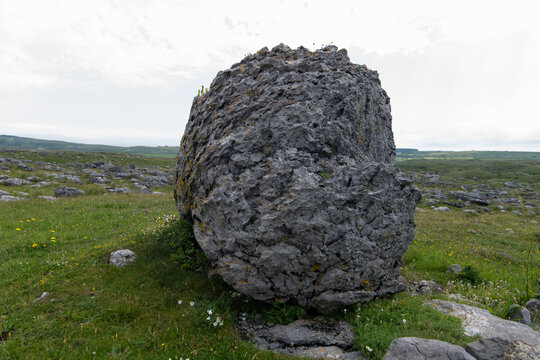 A limestone erratic boulder, a massive rock deposited by glaciers. It is located in the Burren landscape of County Clare, Ireland.