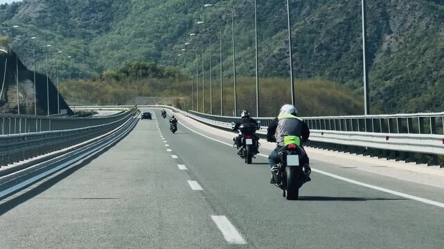 Motorcyclists on scenic highway journey through mountain landscape