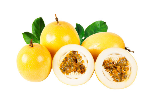 Group of fresh yellow passion fruits with sliced halves revealing aromatic pulp and seeds, decorated with green leaves and isolated on a white background