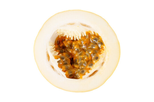Close up of a sliced yellow passion fruit showing fresh pulp and seeds isolated on a white background