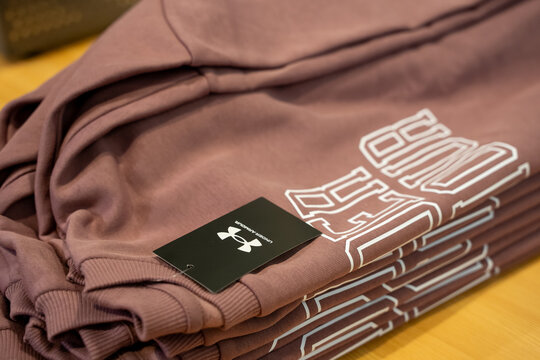 Close up of folded Under Armour sweatshirts in store. Toronto, Canada - July 13, 2026.