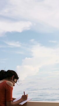 Traveler writing a bucket list with dreamy coastal atmosphere, cinematic sky and vast copy space, minimalist luxury travel concept, emotional lifestyle storytelling, premium tourism advertising backgr