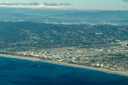 Aerial view of the Santa Monica and Venice Beach coastline with the Santa Monica Mountains and Los Angeles basin beyond, taken after departure from Los Angeles International Airport, California, USA