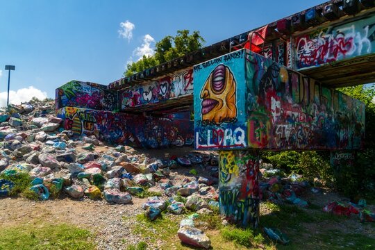 Colorful graffiti-covered bridge and painted rocks in Austin