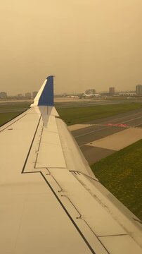 Toronto, Ontario, Canada - July 15, 2026 - Aircraft wing enveloped in thick wildfire smoke haze during landing at YYZ Toronto Pearson during wildfire smoke emergency