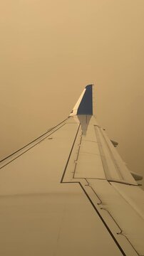 Toronto, Ontario, Canada - July 15, 2026 - Aircraft wing enveloped in thick wildfire smoke haze on approach to YYZ Toronto Pearson during a period of severe air quality deterioration from wildfires