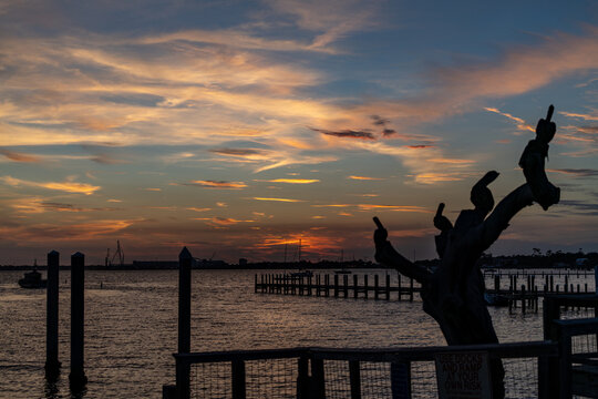 Colorful sunset over harbor with wooden pier and docks