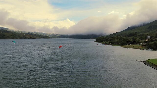 scenic aerial landscape of calima lake with mountains and clouds