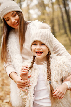 Close up portrait of a girl who playing and having fun in autumn forest