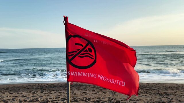 Red warning flag on a beach indicating that swimming is prohibited