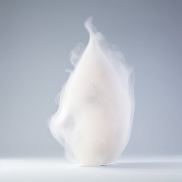 A translucent, lung-shaped glass sculpture with white mist rhythmically forming and dissipating inside. event programs.