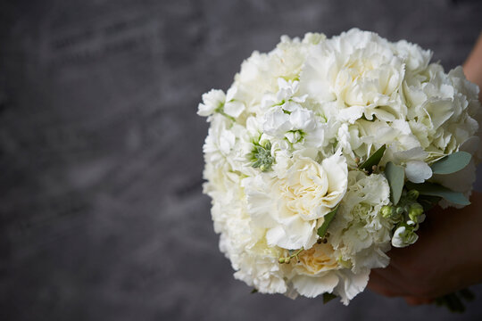 A woman holding a wedding bouquet