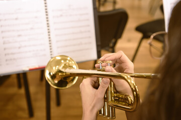 Close-up of hands playing a trumpet during a music rehearsal - horizontal © Natsky