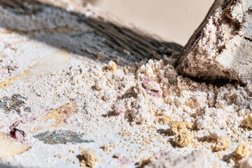 Fototapeta premium Flour and bread crumbs on a weathered oak surface with soft fruit stains for Rosh Hashanah food editorials and seasonal autumn backgrounds