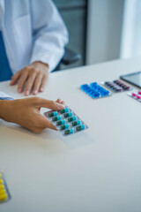 Naklejka premium Pharmacist handed pack of medicine to patient