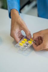 Obraz premium Patient taking medication out of pack