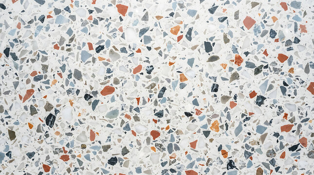 White terrazzo surface with scattered chips of orange blue gray and black background texture