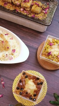 oum ali dessert, baklava, raisin pannacotta, and almond pannacotta are neatly arranged on the table