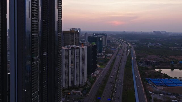 Traffic flow on Nehru ORR with blue sky and high-rise building at kokapet, Narsingi, hyderabad, telangana, india. day time, trucking shot, drone shot, 4k.