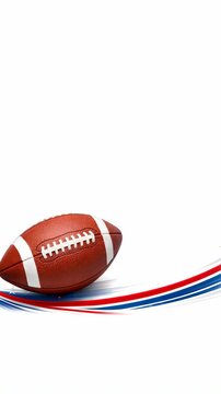 of an American football on a white surface with an of the American flag in the background.