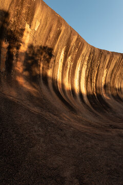 Wave Rock, or Katter Kich, is a huge, breaking wave shaped geological granite feature in Western Australia, Australia. Illuminated by evening light.
