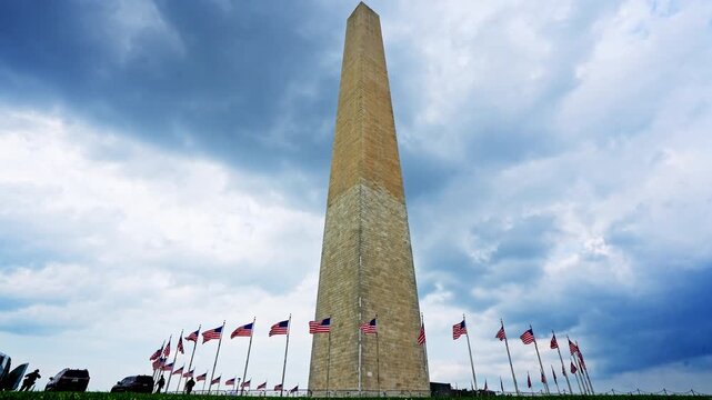 Washington Monument iconic national landmark. American flags at Washington Monument. Washington DC obelisk symbol of freedom. National Mall with Washington Monument.