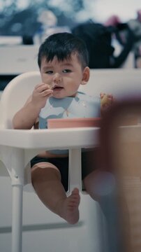 Cute Asian Toddler Eating Finger Food at Home, Healthy Childhood and Family Lifestyle in 4K	
