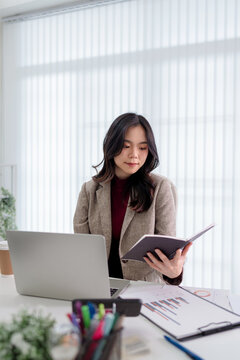 Portrait of confident Asian businesswoman working in office