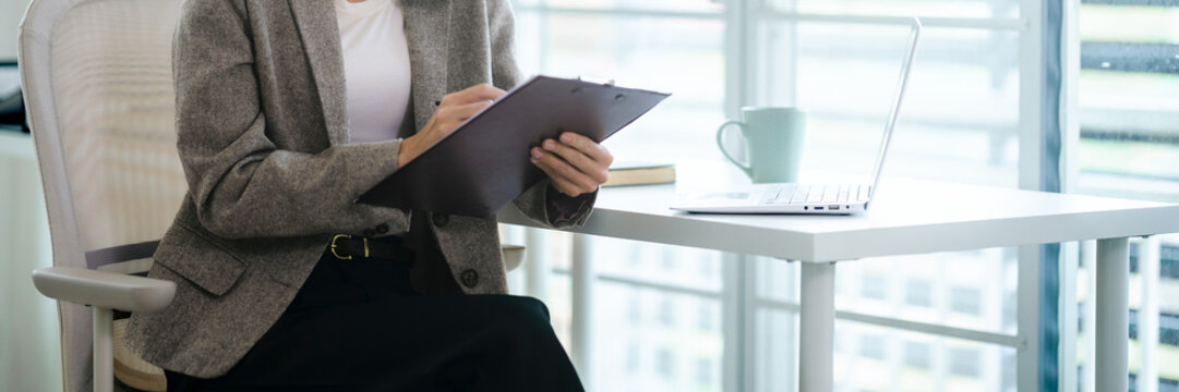 Professional woman focusing on important document at office work environment