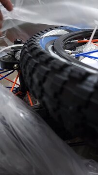 Cutting Plastic Cable Tie on a Bicycle Tire with Scissors