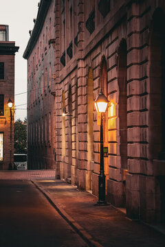 Nostalgic Twilight: Vintage Lamppost Illuminating a Quiet Brick Street