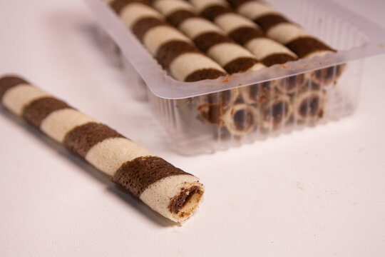 Chocolate wafer rolls with chocolate cream filling isolated on white background