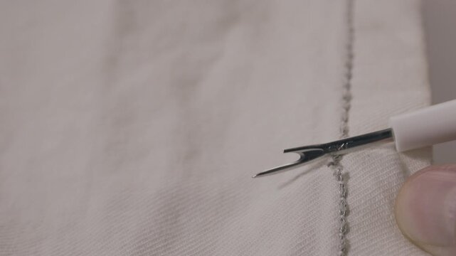 Removing gray thread with seam ripper
