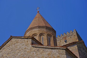 Obraz premium Ancient Ananuri fortress church dome and stone tower with sky copy space