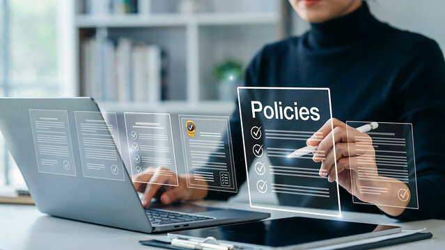 Business professional reviewing company policies on a digital transparent screen