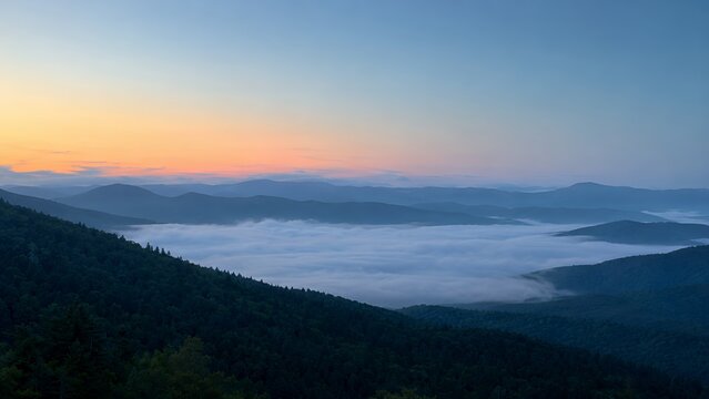 Dawn Over Misty Peaks: Serene Mountain Landscape with Rolling Clouds