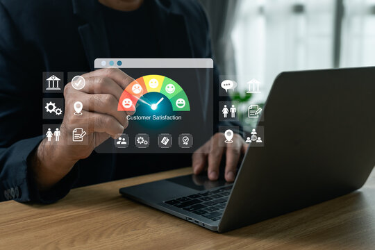 Businessman pointing at a virtual customer satisfaction gauge interface while working on a laptop, concept of business evaluation, user feedback, and service rating