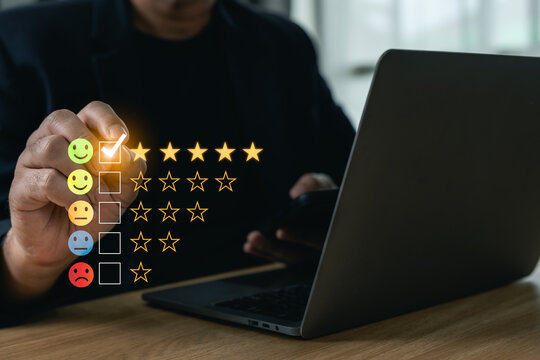 Businessman selecting a five-star rating with an excellent smiley emoji on a virtual feedback interface, concept of customer satisfaction, quality service evaluation and review