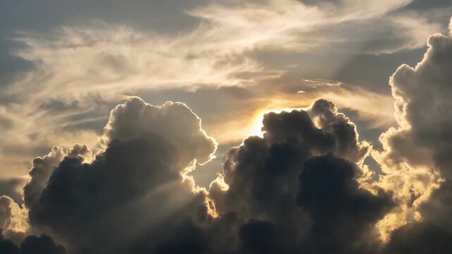 Low angle timelapse sun on blue sky concept. Dramatic sky with sun rays shining through dark and light clouds during sunset