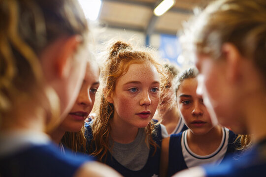 Girls Sports Team Huddle Before Game in Indoor Arena