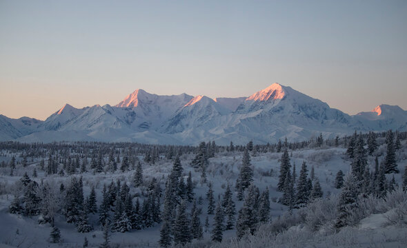 Sun shining on top of mountain on the winter solstice in Alaska