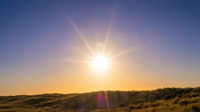 Low angle timelapse sun on blue sky concept. Bright sunny landscape with clear blue sky and grassy hill at golden hour