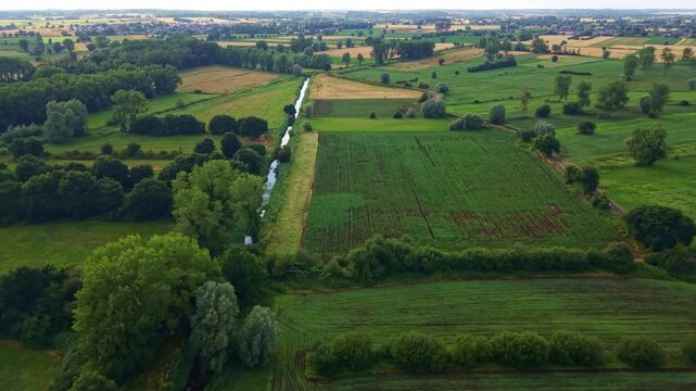 A patchwork of fields and hedgerows stretches across the French countryside.