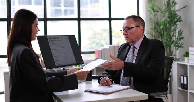 Young businesswoman attending a job interview, holding a document while a male recruiter reviews applicants on a clipboard, signifying human resources, career planning, and new employment