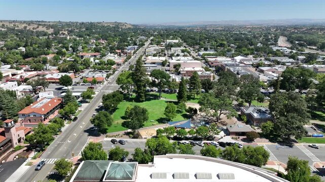 Paso Robles, California, USA - Rightward Aerial Drone View of Historic Downtown Paso Robles with Rolling Vineyards and Central Coast Wine Country on a Sunny Day