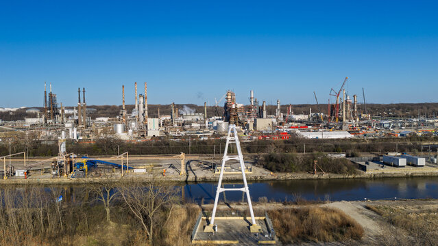 Industrial oil refinery complex sprawling along a river